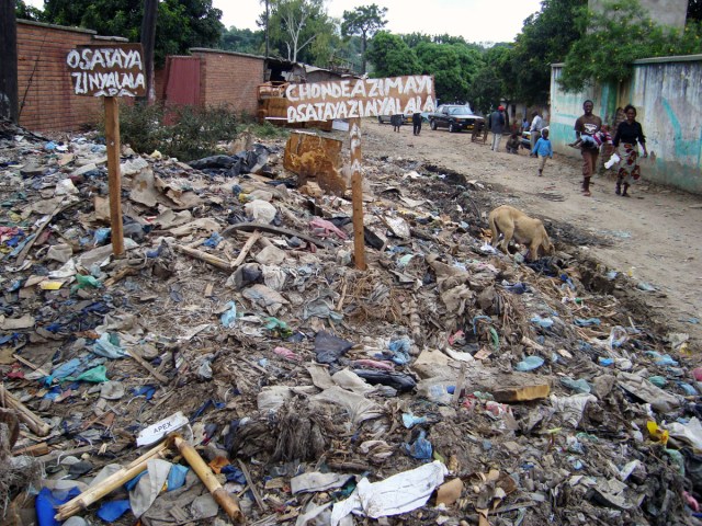 A "do not litter" sign surrounded by a sea of garbage in Malawian suburb, Ndirande. The roadside has become an informal dumpsite for residents and market traders. Photo by Sarah Berman.